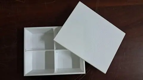 The Nutri-Mithu meal box, a white lunch box with removable internal dividers