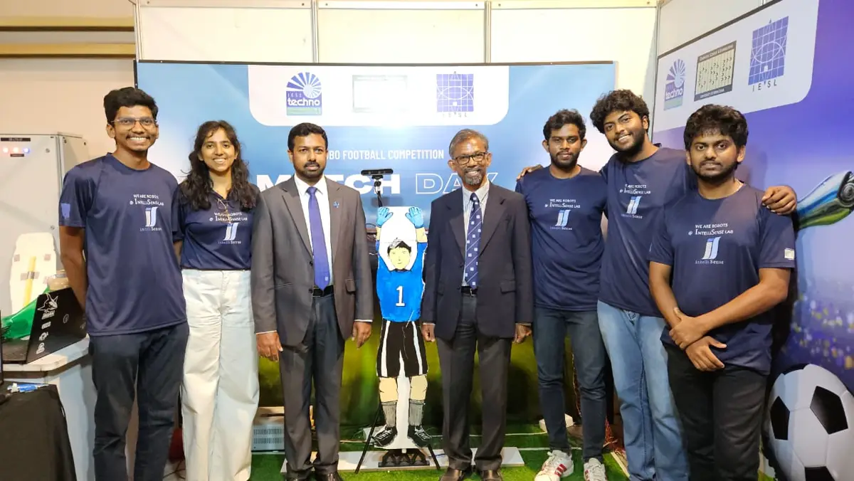 The team beside the goalkeeper robot at the IESL Techno 2025 stand